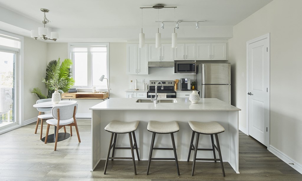 a kitchen with a large island and bar stools