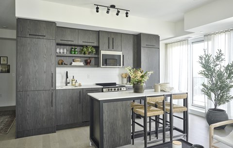 a kitchen with an island and stools in a house