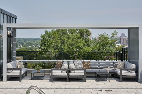 a terrace with couches and tables on a roof top