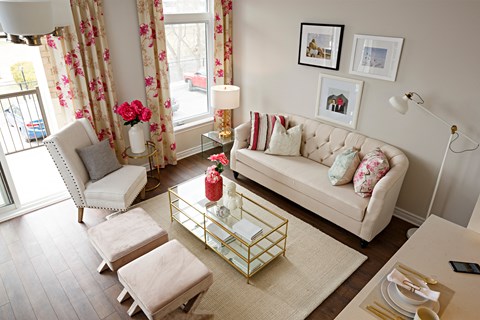 a living room with a couch and two chairs and a coffee table