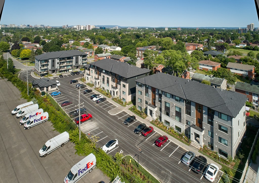 an aerial view of a neighborhood with cars parked in a parking lot