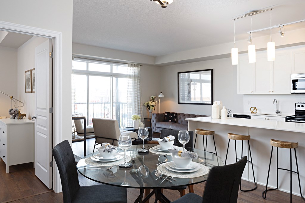 a living room and dining room with a glass table