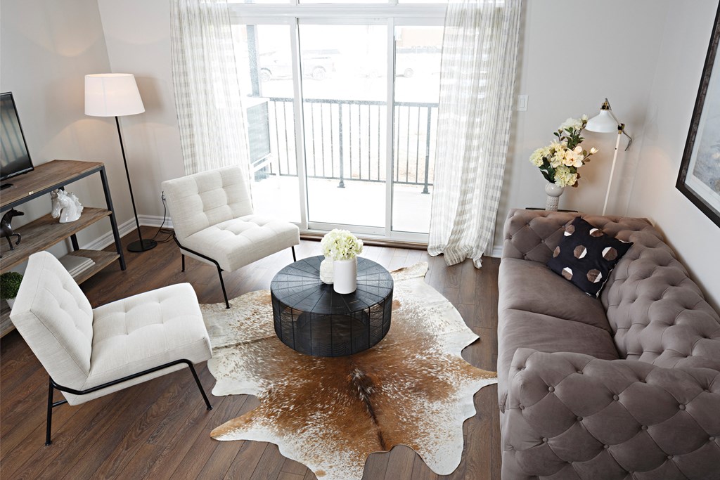 a living room with a couch and chairs and a coffee table
