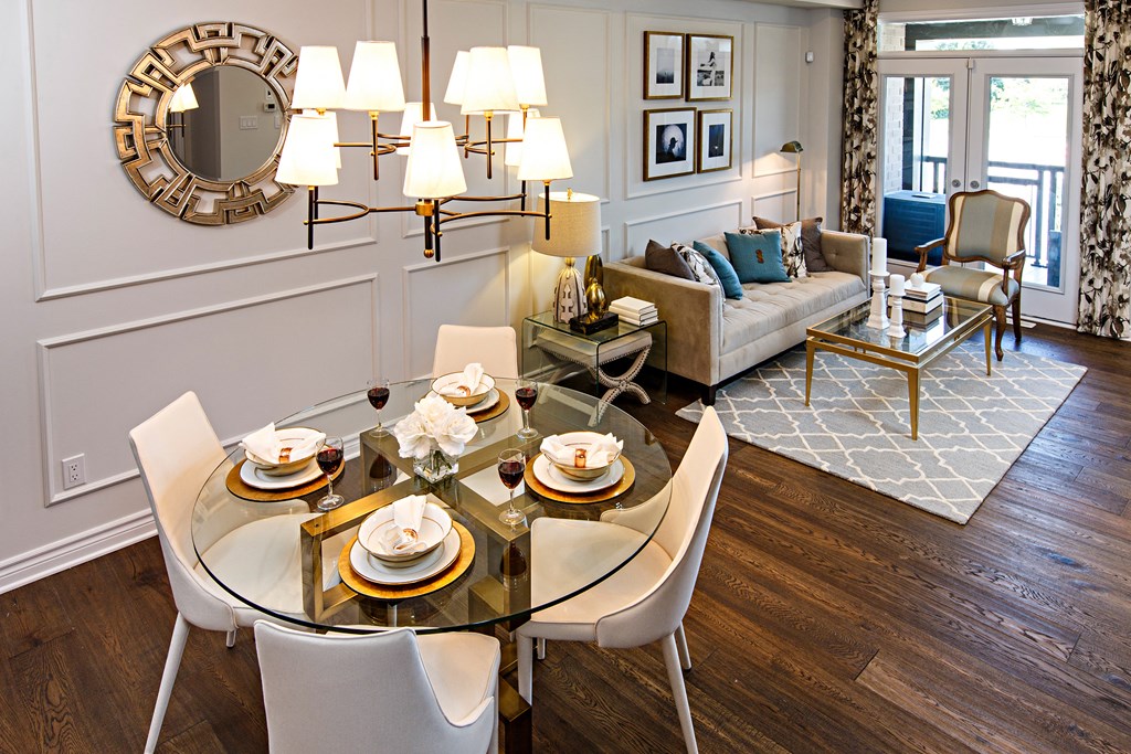 a dining room with a glass table and chairs
