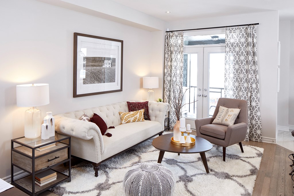 a living room with a couch and a chair and a table