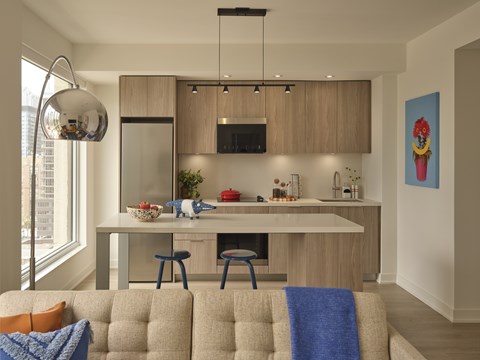 A modern kitchen with a dining area and a living room.