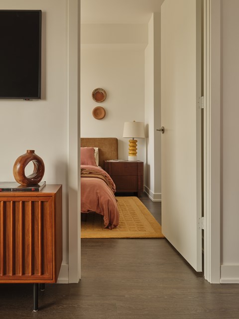 A bedroom with a bed and a lamp on the side table.
