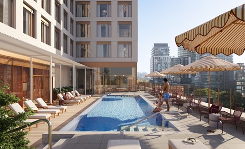 A large outdoor pool area with sun loungers and umbrellas.