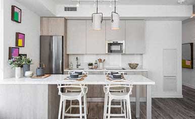 A kitchen with a white table and chairs.