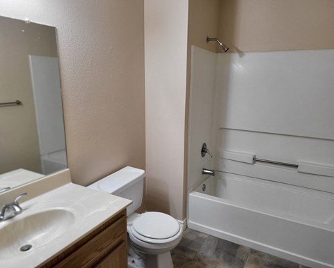 an empty bathroom with a toilet sink and shower