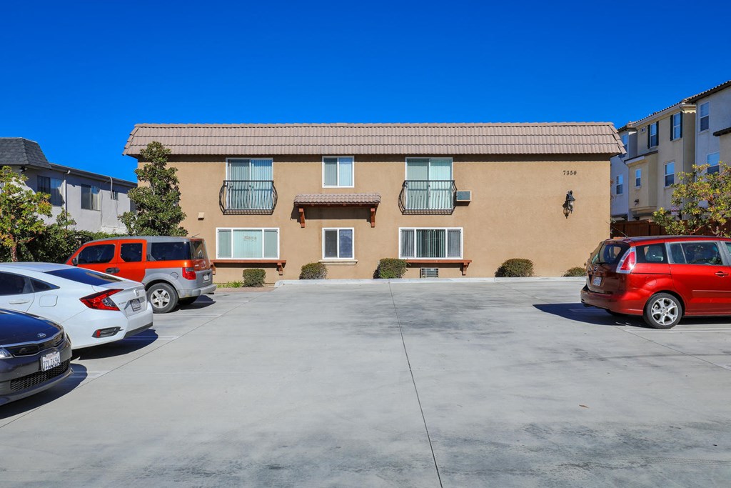 a parking lot with cars in front of a building