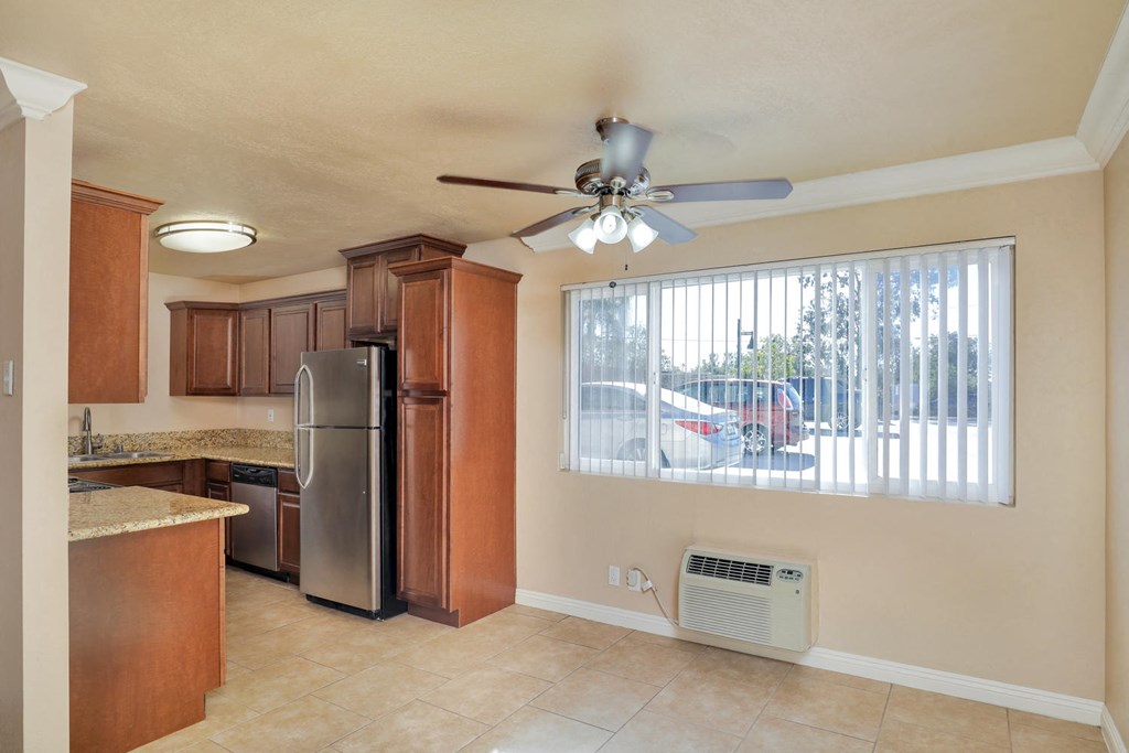 a kitchen with stainless steel appliances and a ceiling fan