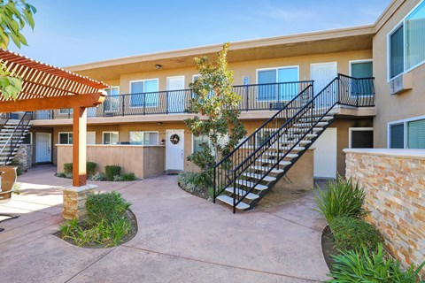 the entrance to an apartment building with a staircase