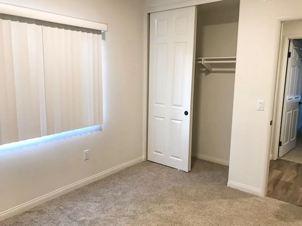 a room with a closet and a window and a door