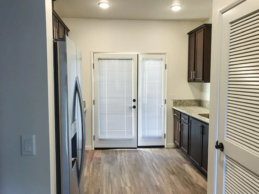 a kitchen with a refrigerator and a door to a closet