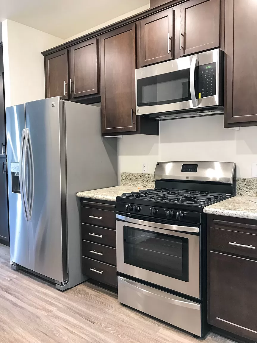 a kitchen with stainless steel appliances and wooden cabinets