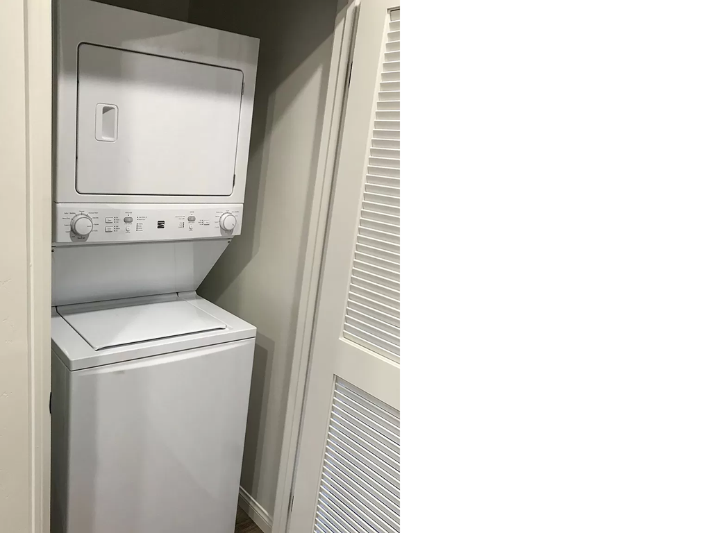 a white washer and dryer in a closet