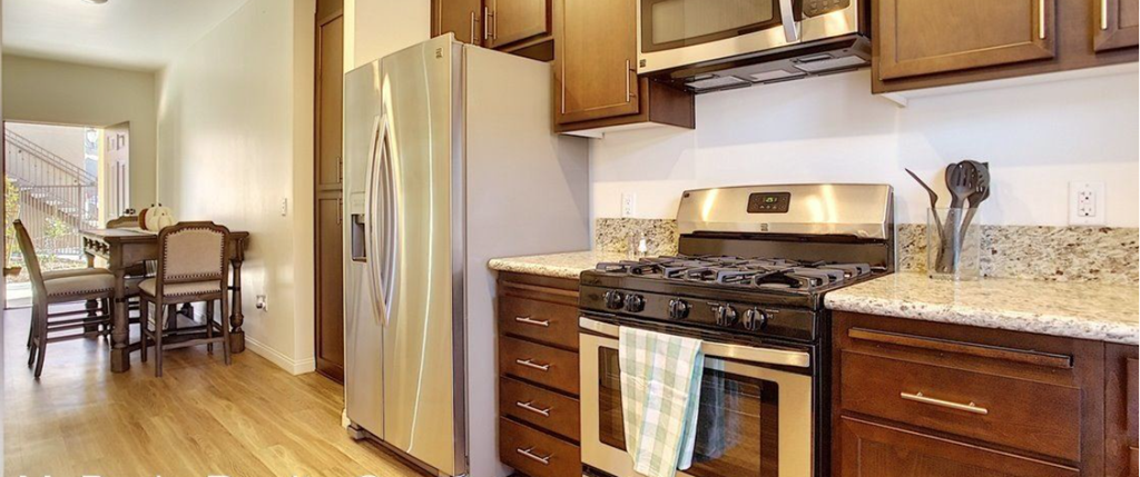 a kitchen with a stove and a refrigerator