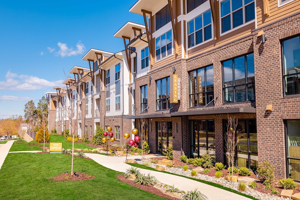 an exterior view of an apartment building on a sunny day
