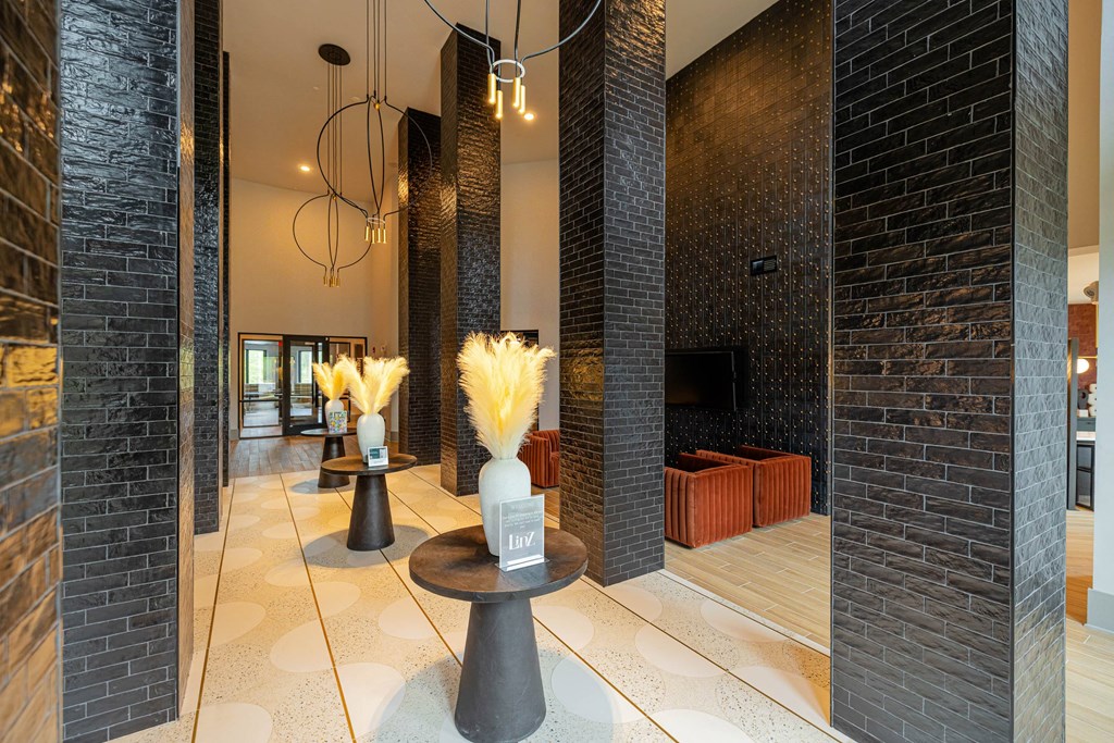 the lobby or reception area of a hotel with a fireplace