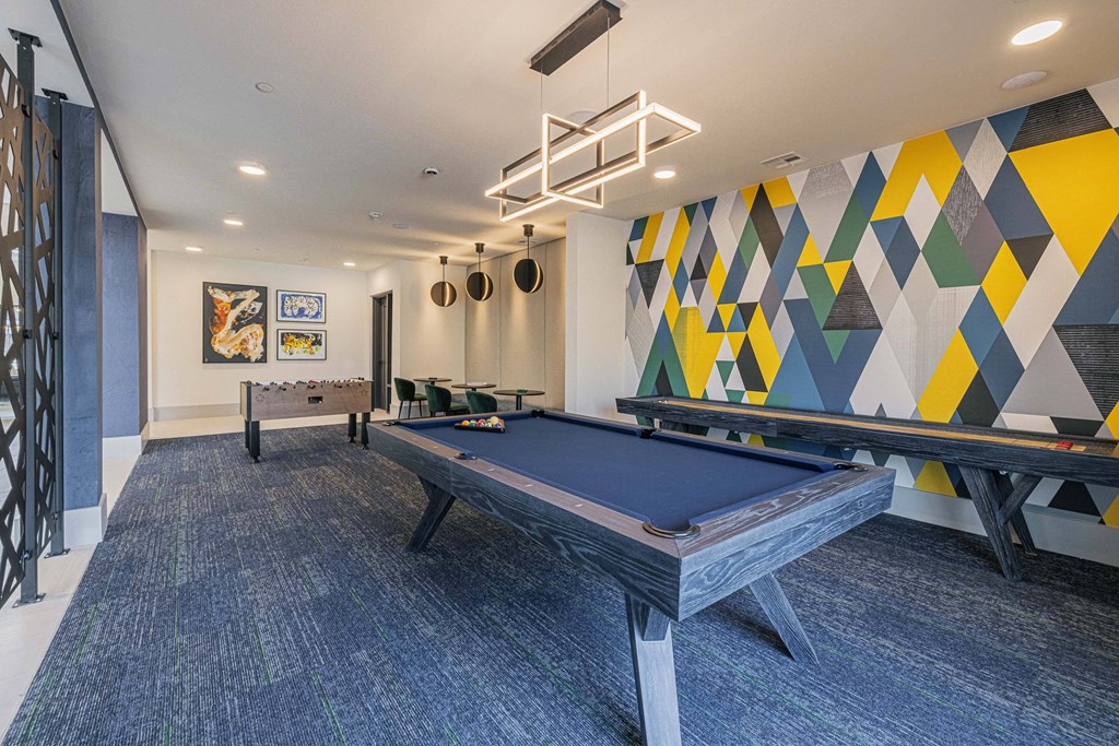 a games room with a pool table and ping pong