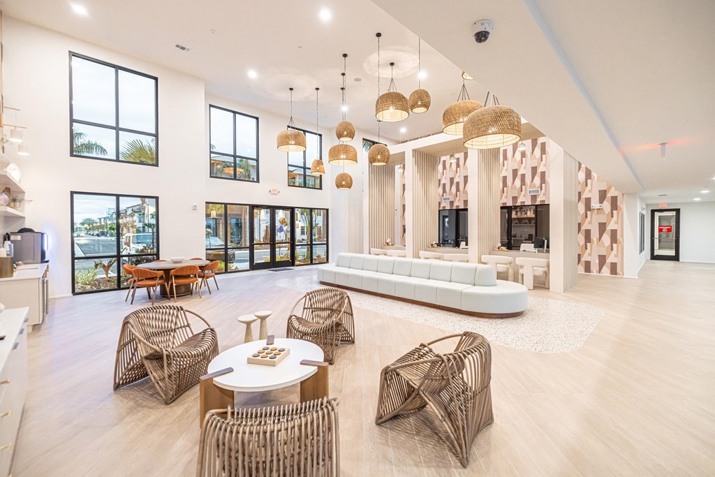 A spacious room with a white table and chairs.