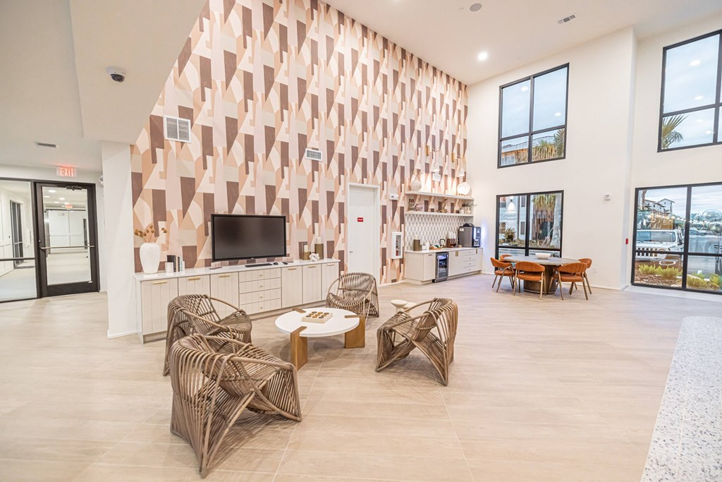 A modern living room with a large TV and a unique wall design.