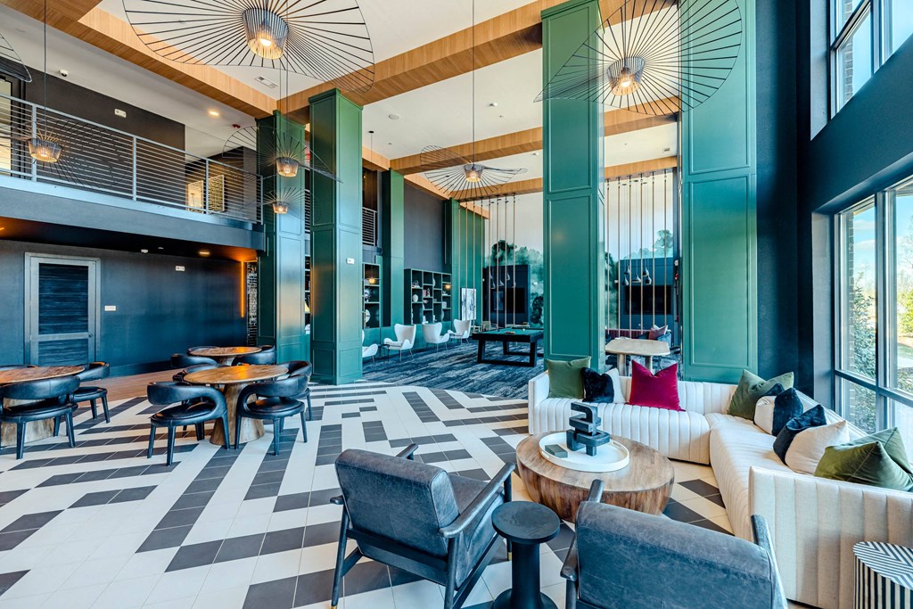 the lobby of a hotel with couches and tables