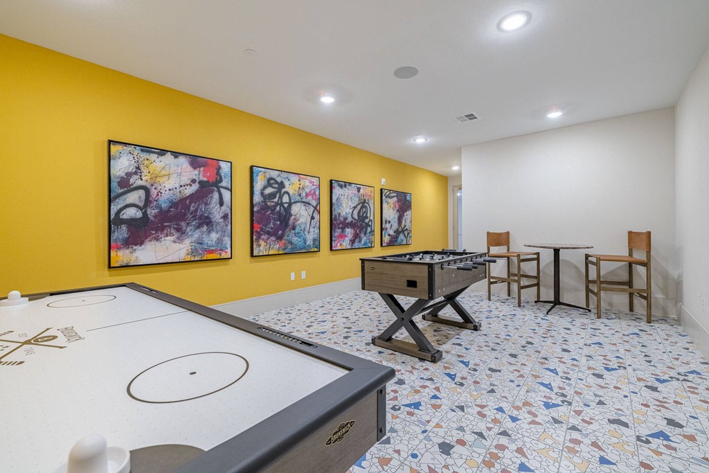 a game room with a foosball table and a ping pong