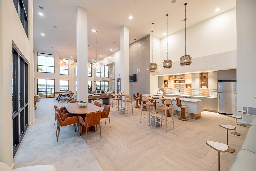 A modern kitchen and dining area with a long table and chairs.