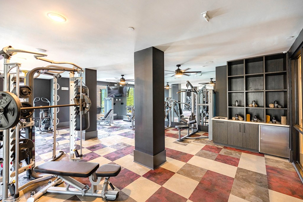 a gym with weights and other equipment on a checkered floor