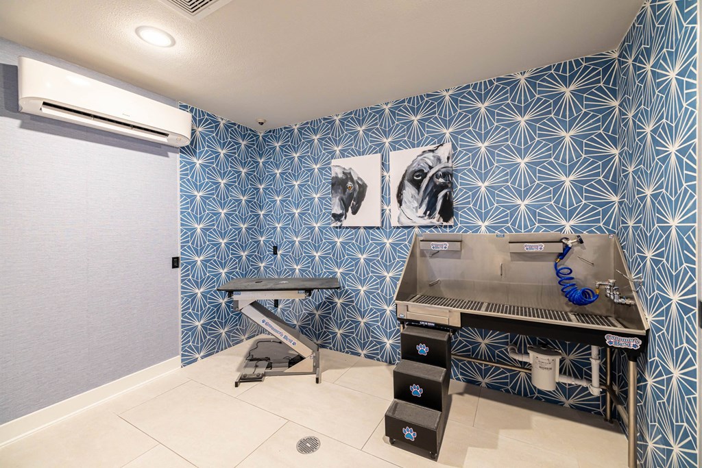 a home gym with a treadmill and a sink