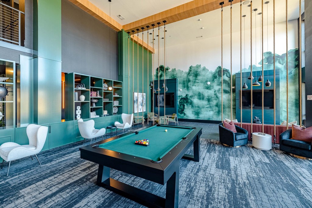 a game room with a pool table and a large wall mural