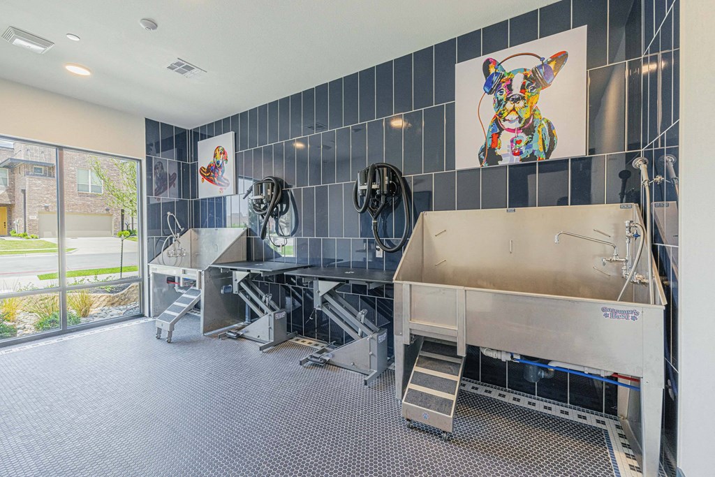 the tasting room has three sinks and two baths and a glass door