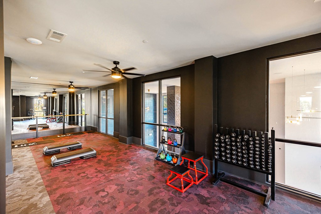 a living room with a crib and a red rug