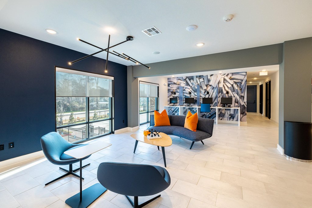 a living room with a couch and chairs and a table