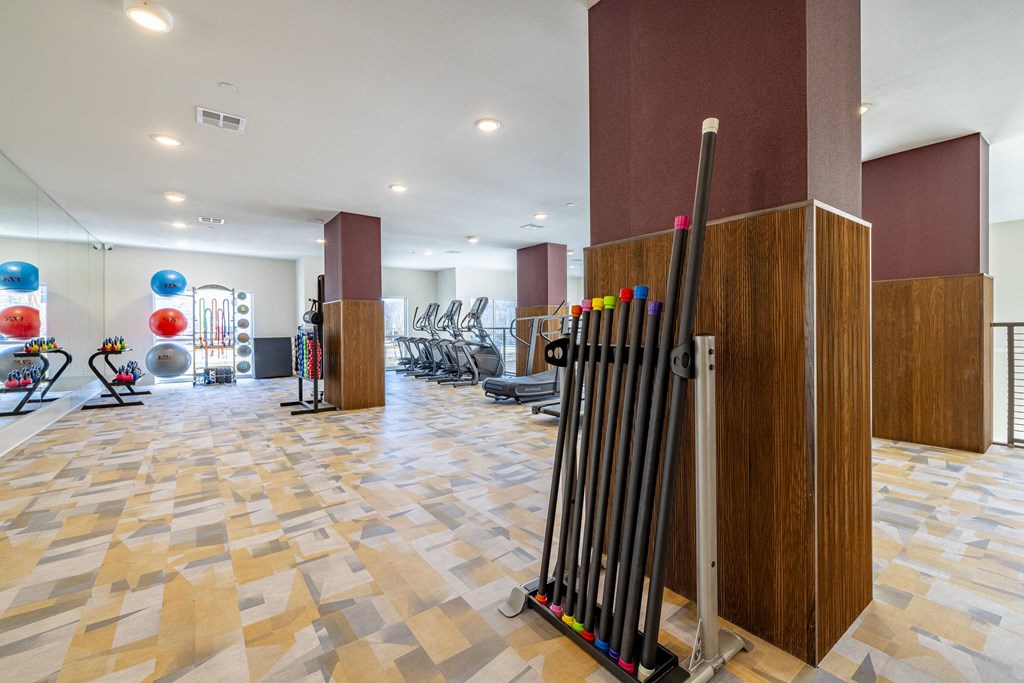 a gym with a bunch of chairs and a row of dividers in a lobby