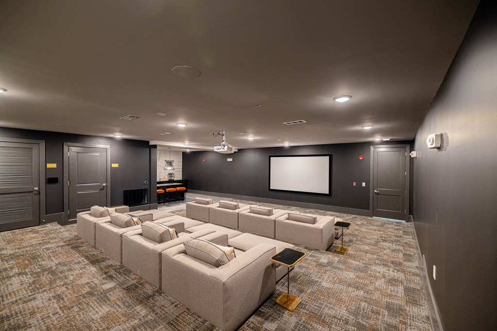 a large screening room with couches and a television
