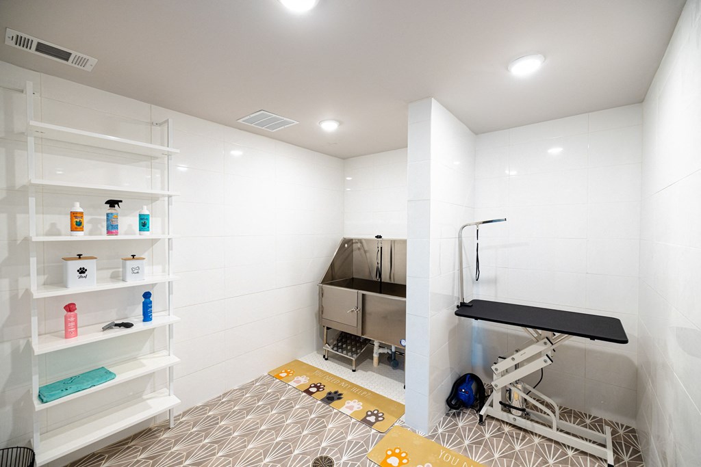 a white bathroom with a shower and a sink and a shelf with a work station