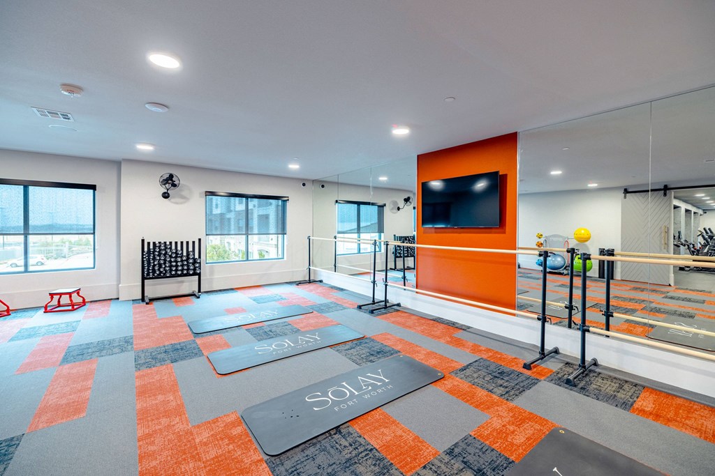 the preserve at ballantyne commons fitness room with yoga mats and a tv