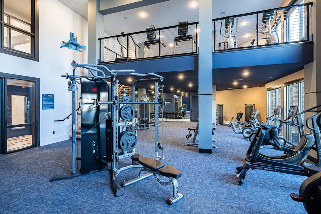 a gym with weights and cardio equipment in therium of a building