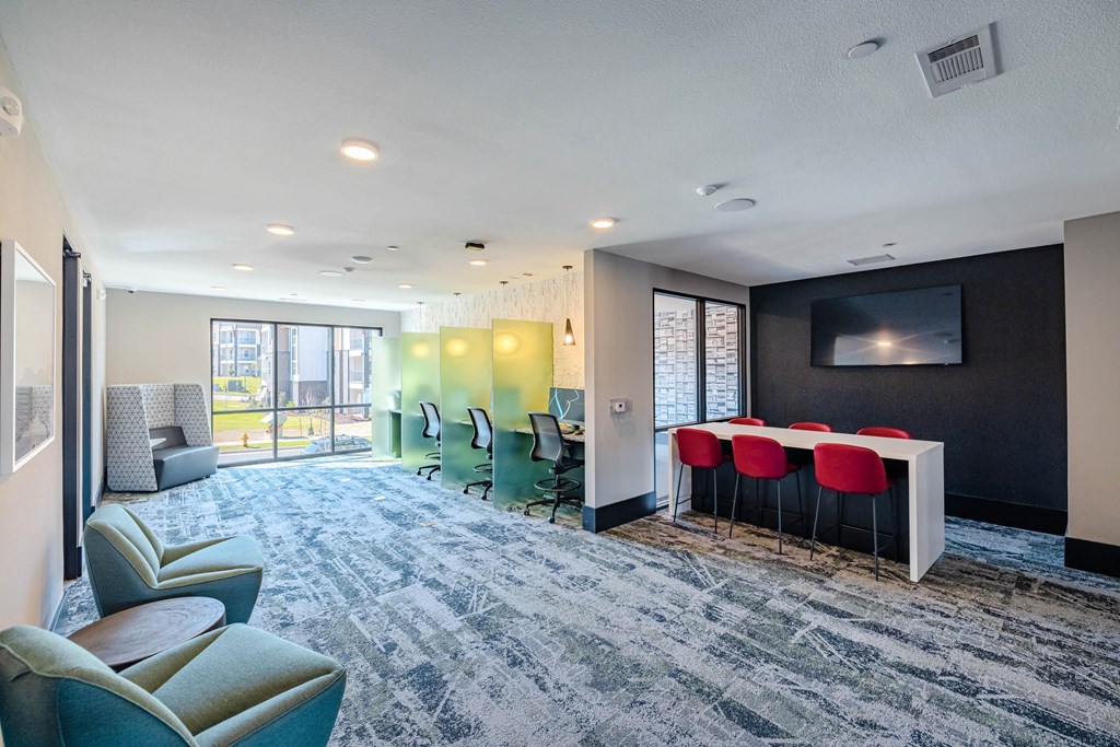 a lounge area with a table and chairs and a tv