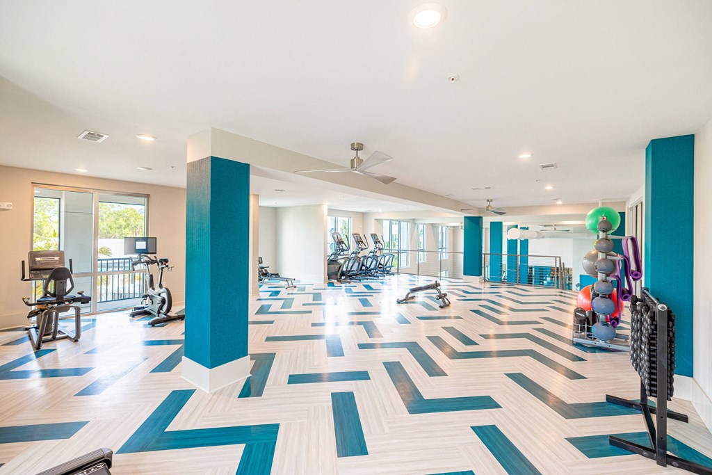 a gym with a checkered floor and a bunch of exercise equipment