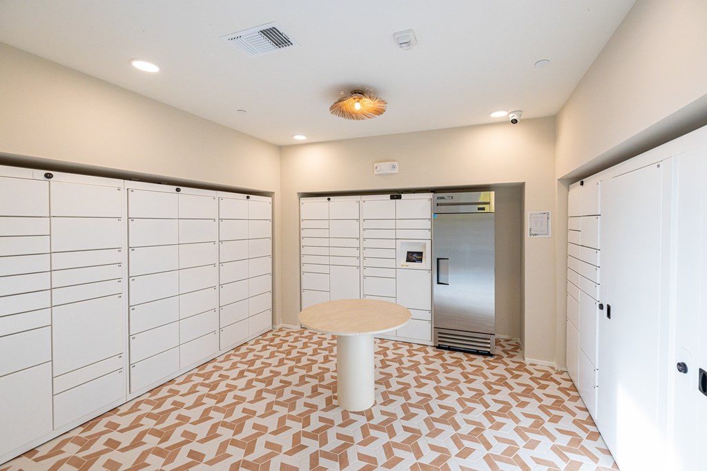 A room with a tiled floor and a refrigerator in the corner.