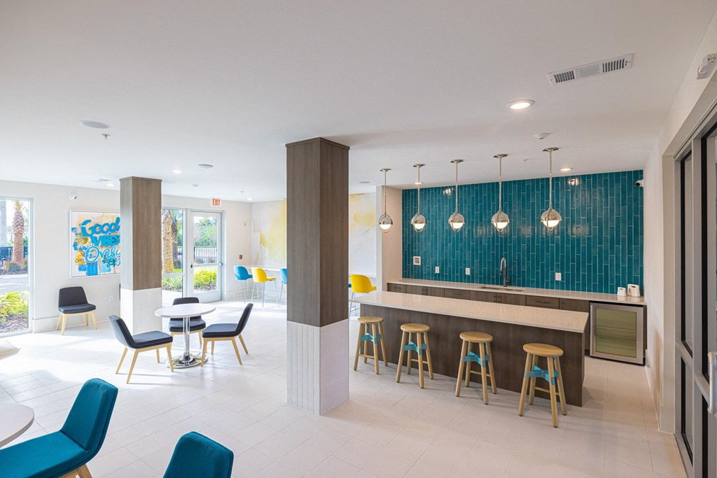 a lobby with a bar and tables and chairs