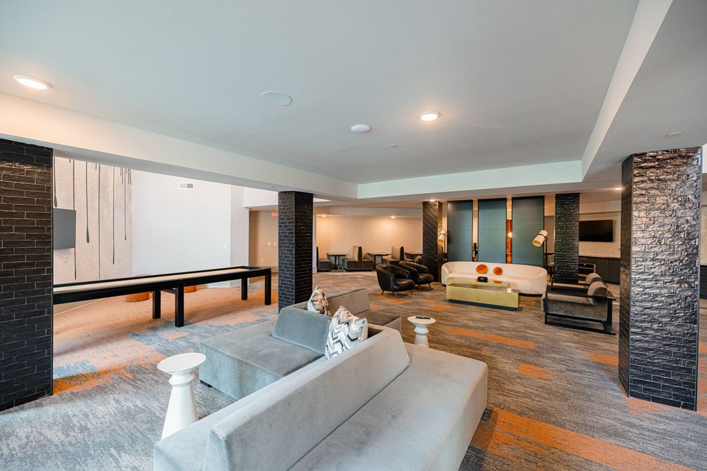 a large living room with a couch and a table