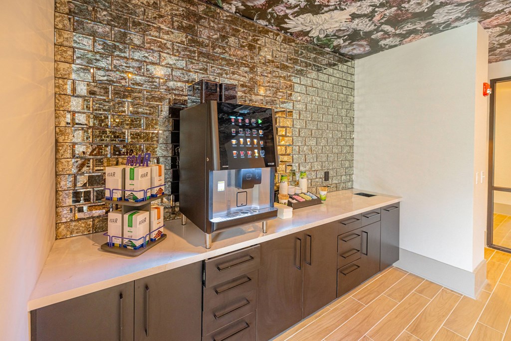 a coffee machine on a counter in a room with a brick wall