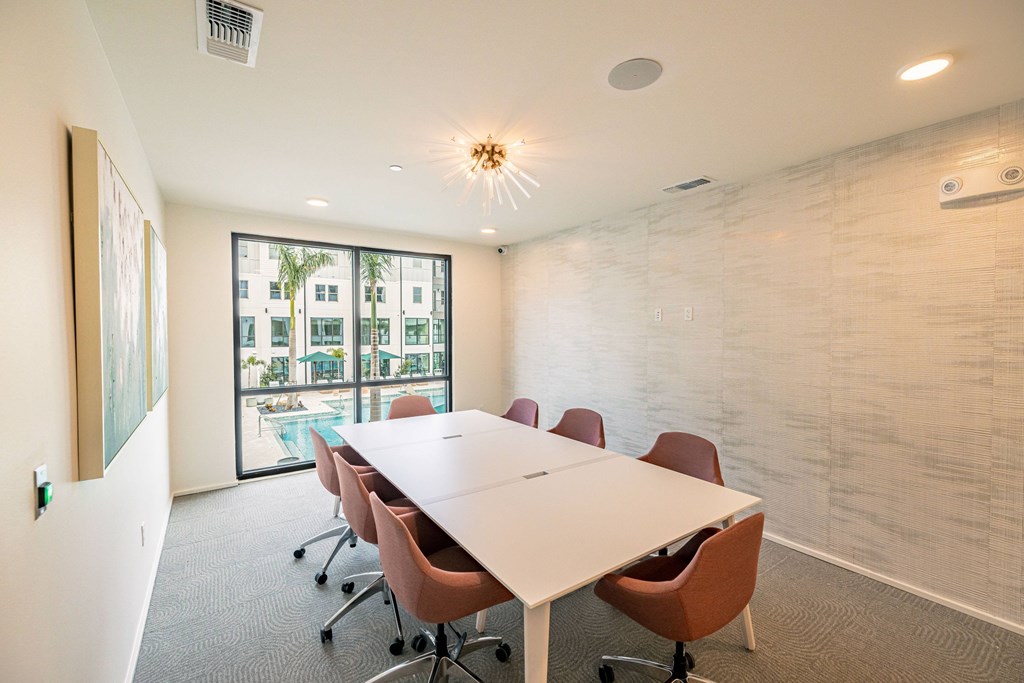 A conference room with a long table and chairs.