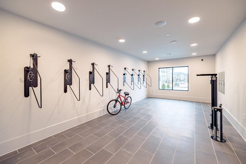 a bike is hanging on the wall in a room with white walls