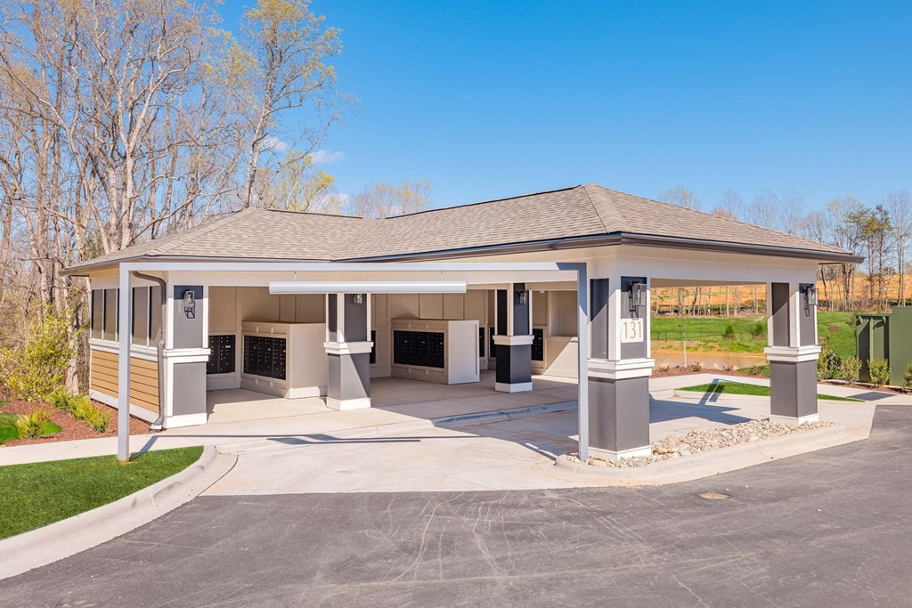 a covered gas station with a driveway and a parking lot